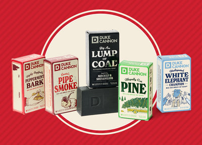 Our Holiday Big Ass Bricks of Soap on a holiday background. Featuring Peppermint Bark, Pipe Smoke, Lump of Coal, Illegally Cut Pine and White Elephant scents.