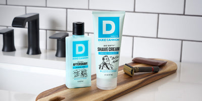 Beard After Shave and Shaving Cream on a sink counter top.