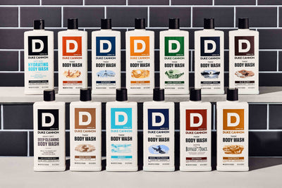 Two rows of all our available THICK Body Washes on a counter with a tile background.