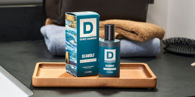 Seawolf Proper Cologne Bottle next to its packaging on a bathroom counter top.