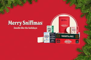 Collection of Christmas-themed products on a red background with 'Merry Sniffmas' text. Smells like the holidays.