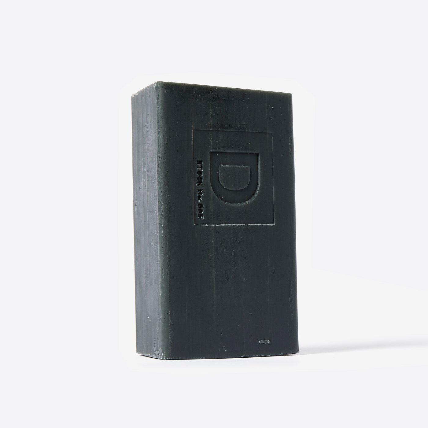 Bar of soap with a Duke Cannon brand logo on a white background. Lump of Coal scent.