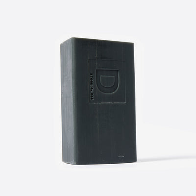 Bar of soap with a Duke Cannon brand logo on a white background. Lump of Coal scent.