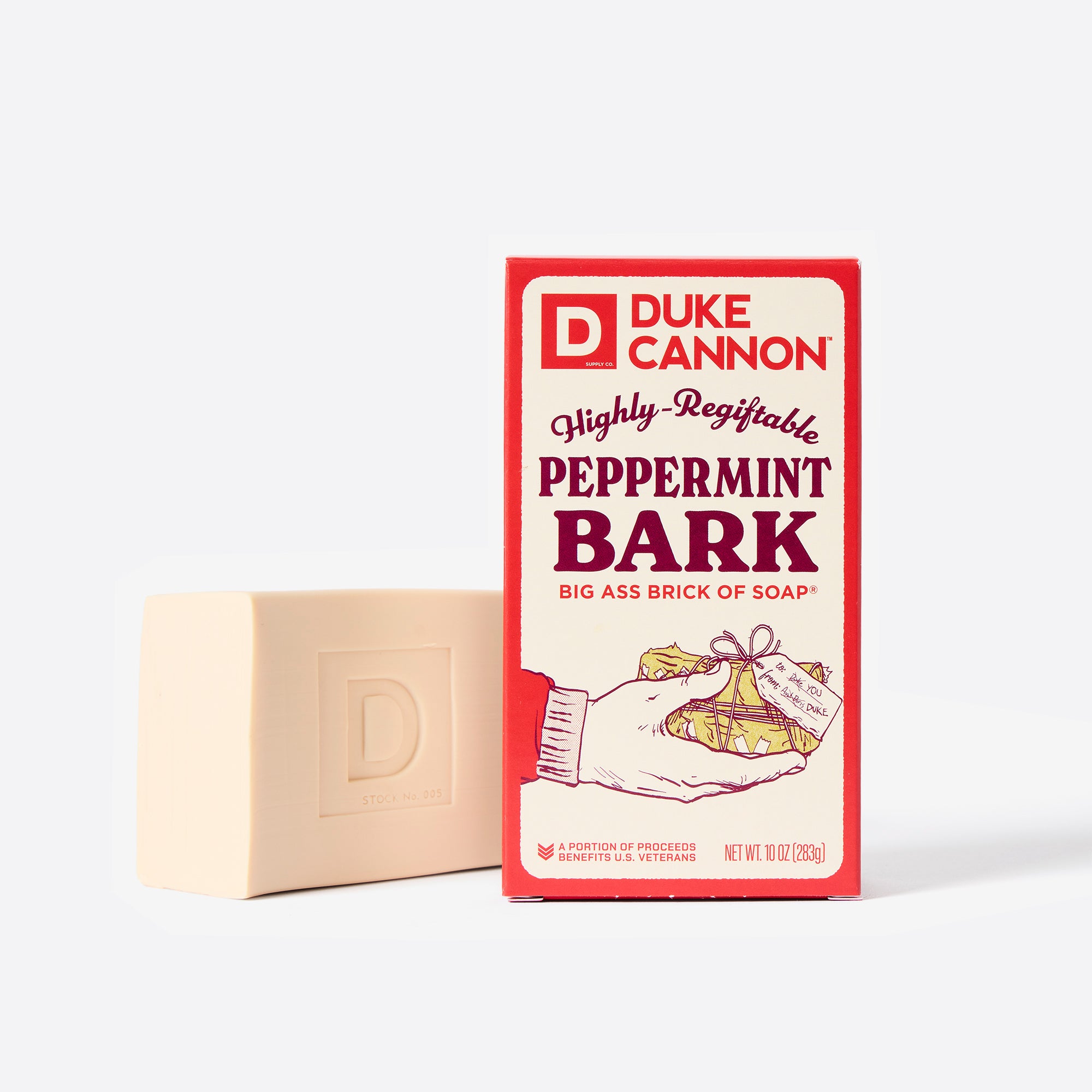 Big Ass Brick of soap next to its packaging with 'Duke Cannon' branding on a white background. Highly-Regiftable Peppermint Bark.