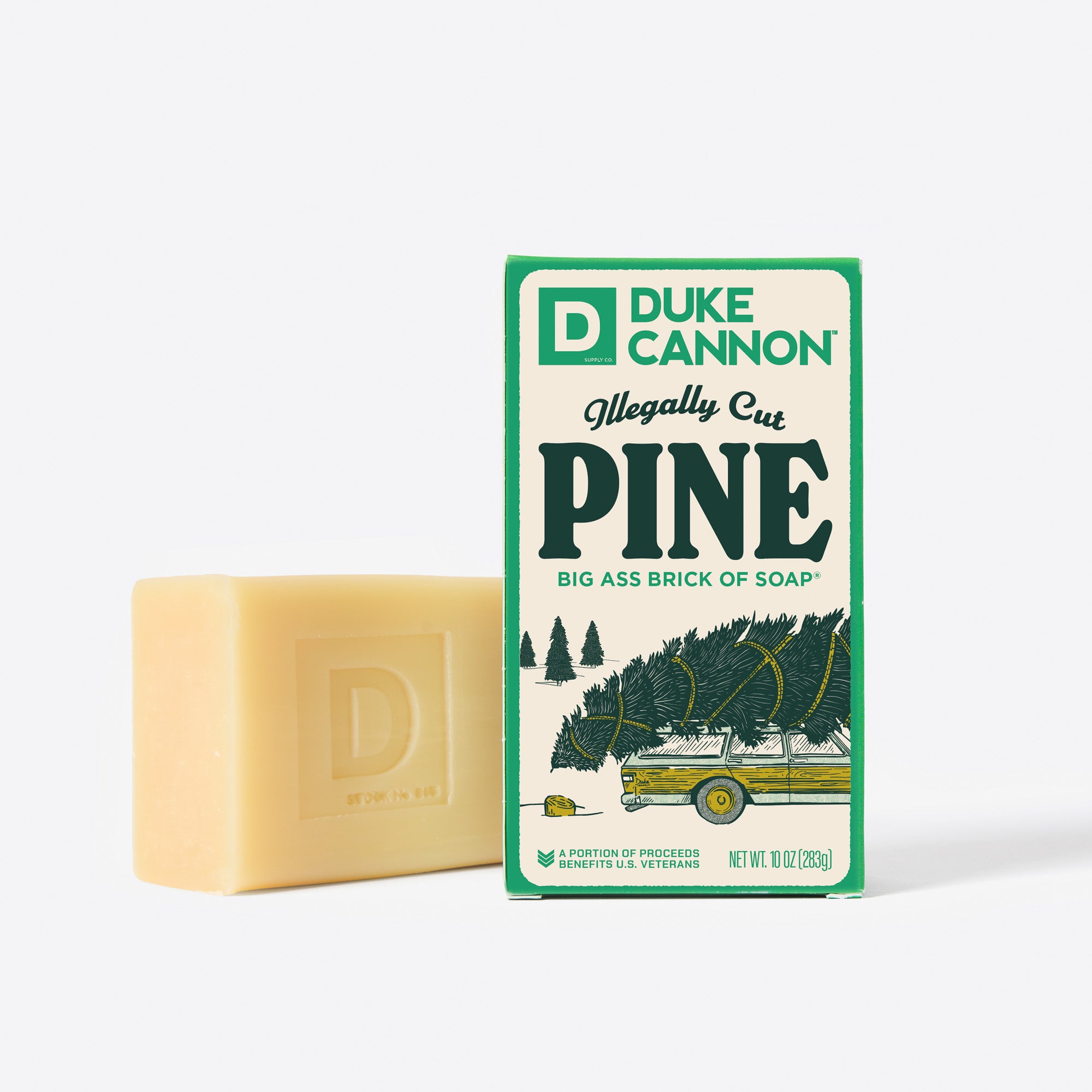 Big Ass Brick of soap next to its packaging with 'Duke Cannon' branding on a white background. Illegally Cut Pine.