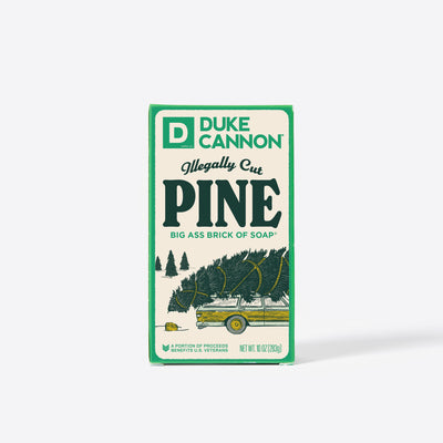Big Ass Brick of soap inside of its packaging with 'Duke Cannon' branding on a white background. Illegally Cut Pine Big Ass Brick of Soap.
