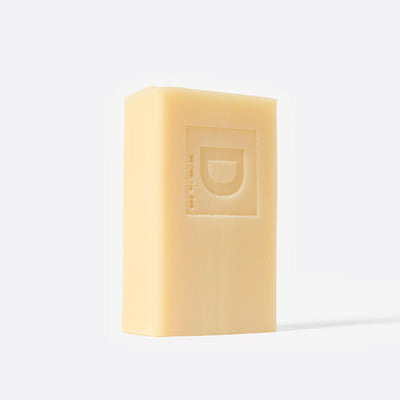 Bar of soap with a Duke Cannon brand logo on a white background. Illegally Cut Pine.