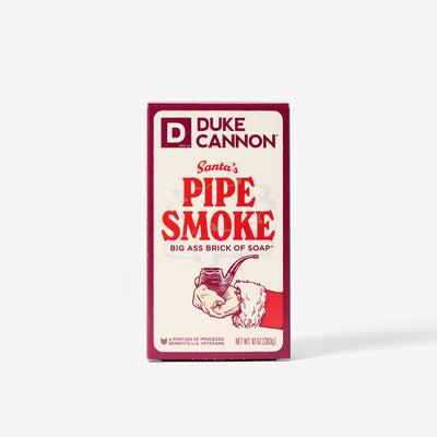 Big Ass Brick of soap inside of its packaging with 'Duke Cannon' branding on a white background. Santa's Pipe Smoke Big Ass Brick of Soap.