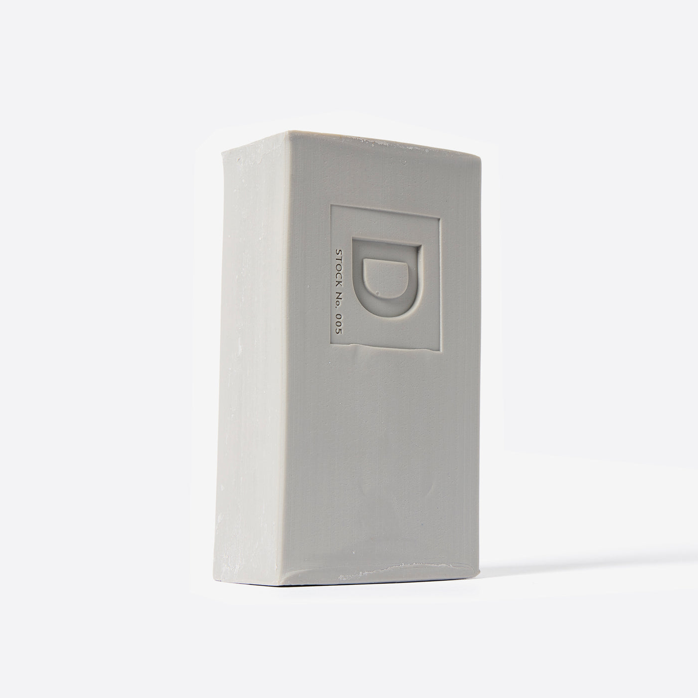 Bar of soap with a Duke Cannon brand logo on a white background. Santa's Pipe Smoke.