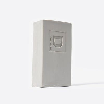 Bar of soap with a Duke Cannon brand logo on a white background. Santa's Pipe Smoke.