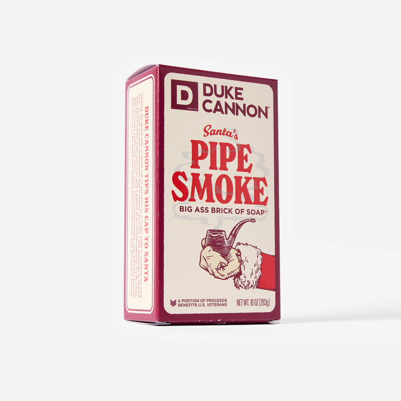 Big Ass Brick of soap inside of its packaging with 'Duke Cannon' branding on a white background. Santa's Pipe Smoke. With creative product description on the side.