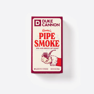 Big Ass Brick of soap inside of its packaging with 'Duke Cannon' branding on a white background. Santa's Pipe Smoke Big Ass Brick of Soap.