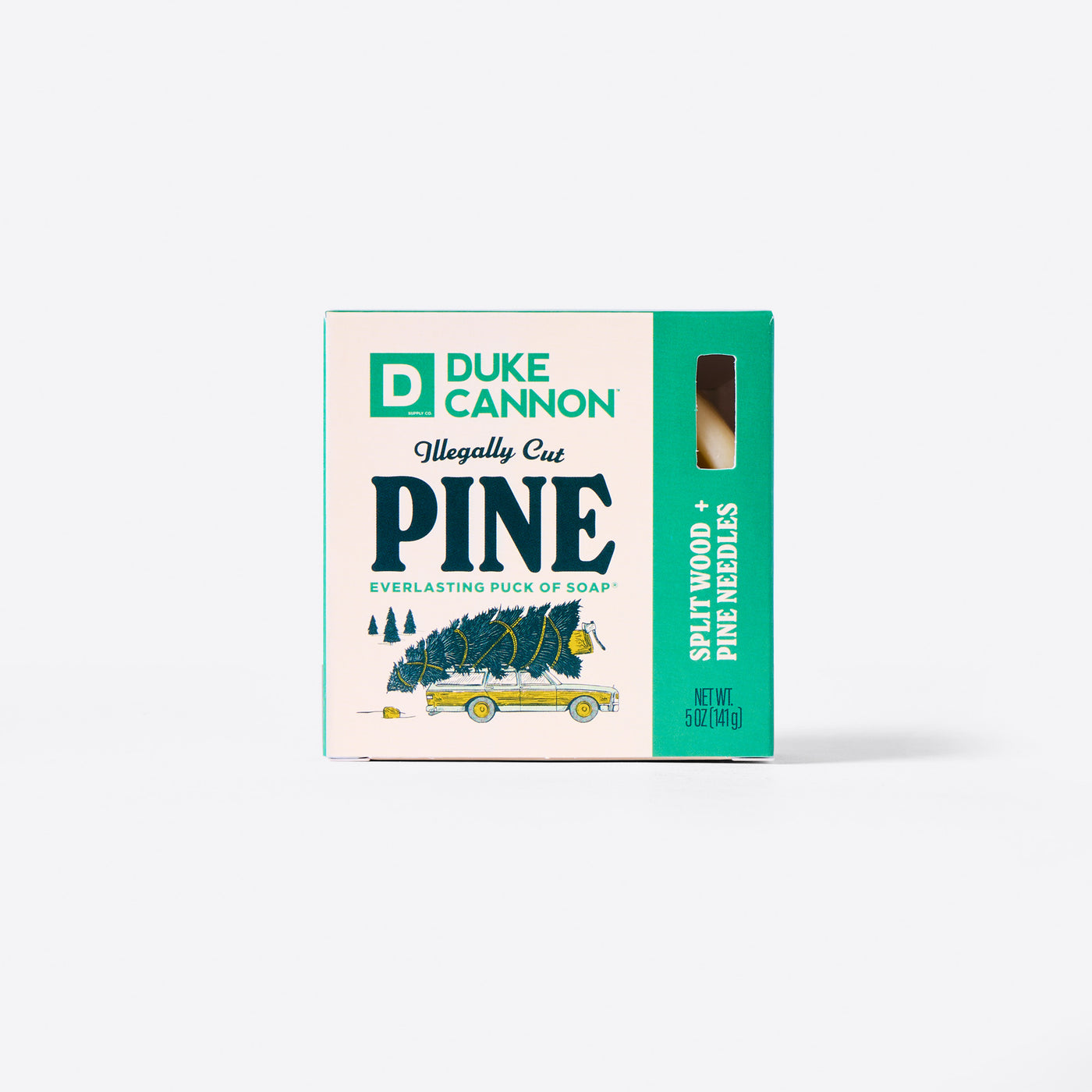 Duke Cannon Illegally Cut Pine Everlasting Puck of Soap packaging with the Soap Puck on the inside. On a white background. Scent is Splitwood + Pine Needles.