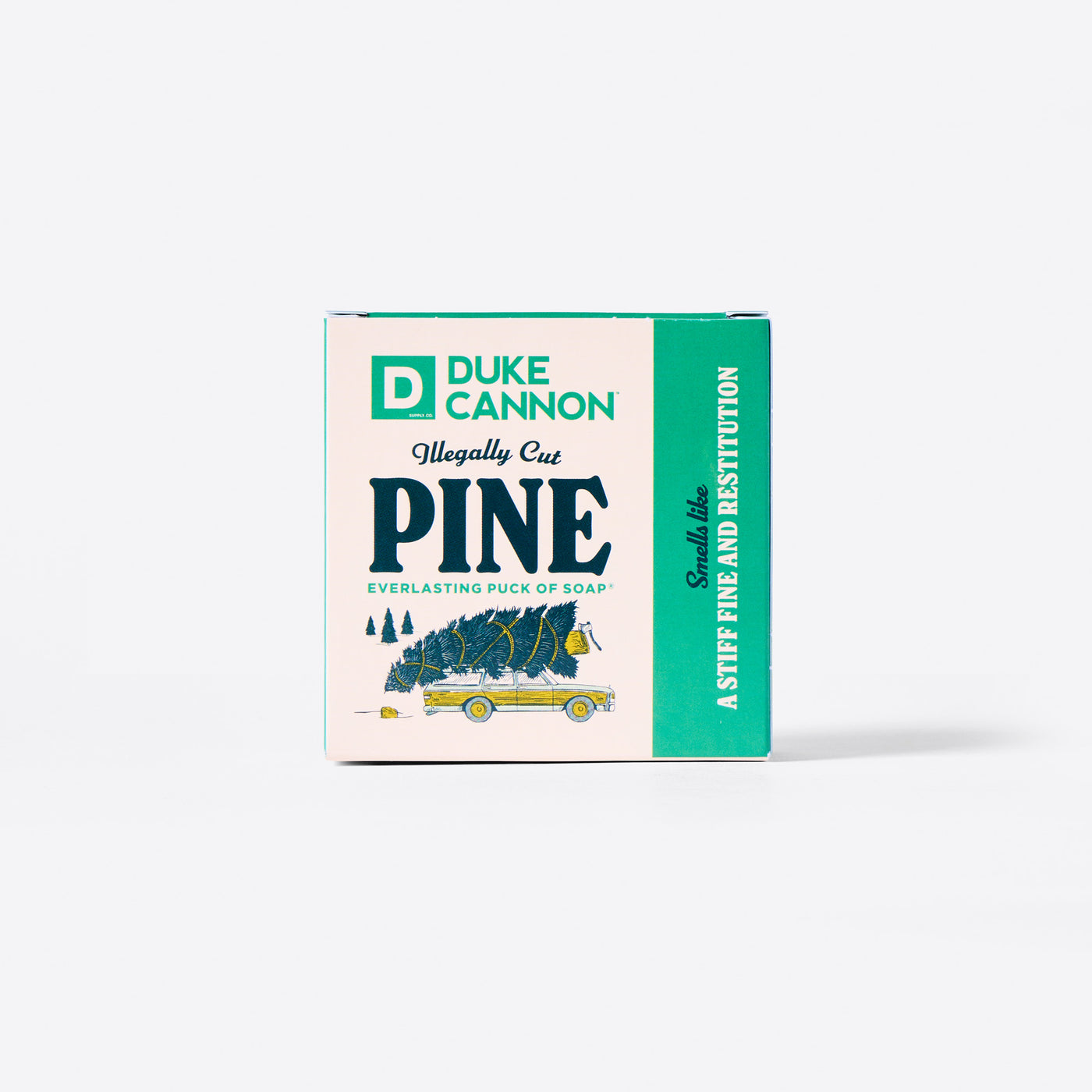 The back of the Duke Cannon Illegally Cut Pine Everlasting Puck of Soap packaging with the Soap Puck on the inside. On a white background. Says, 