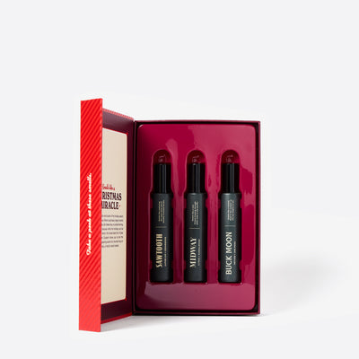 The inside of the Red Holiday Book cologne gift set called Merry Little Sniffmas Vol. 1. It includes a Buck Moon, Midway and Sawtooth cologne ration.
