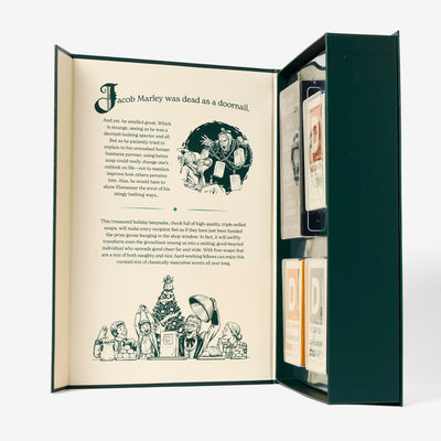 Open Naughty & Nice book that says 'Jacob Marley was dead as a doornail' with the 4 bricks of soap inside.