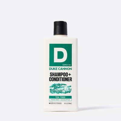 Duke Cannon Tea Tree scented shampoo and conditioner bottle on a white background.  With an illustration of an alligator under a Tea Tree.