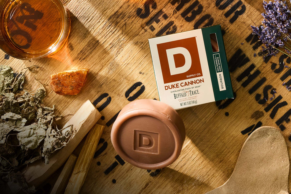 Duke Cannon product on a wooden surface with branding visible